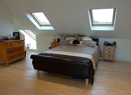 Loft conversion bedroom with velux windows