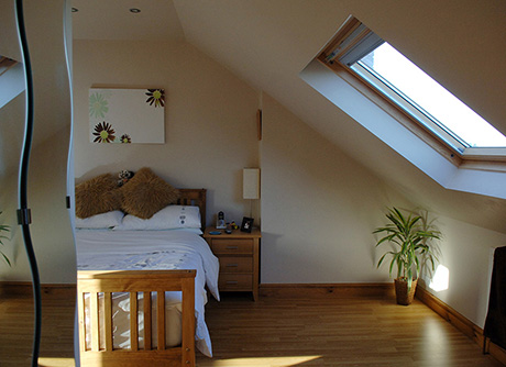 Loft conversion bedroom with velux windows